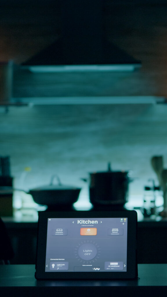 smart application on tablet placed on kitchen desk in empty house